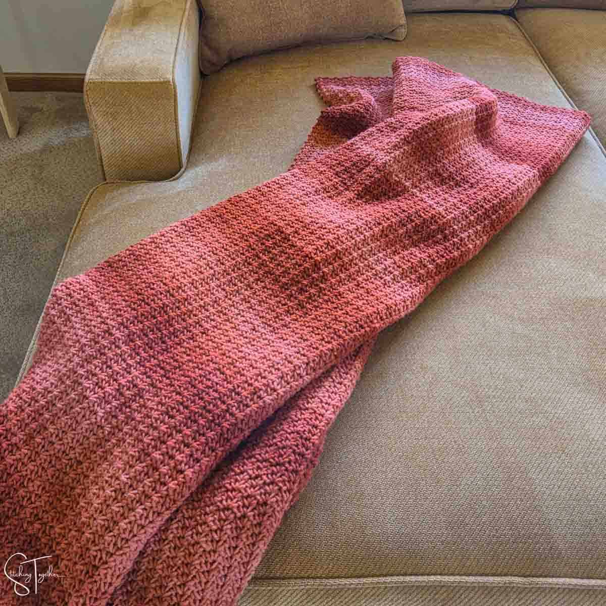 orange crochet throw draped on a couch