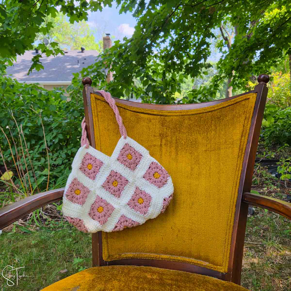 crochet granny square bag on a chair
