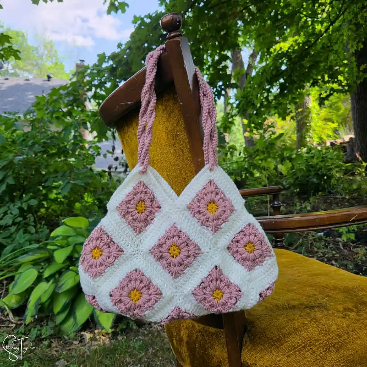 granny purse hanging on the back of a chair
